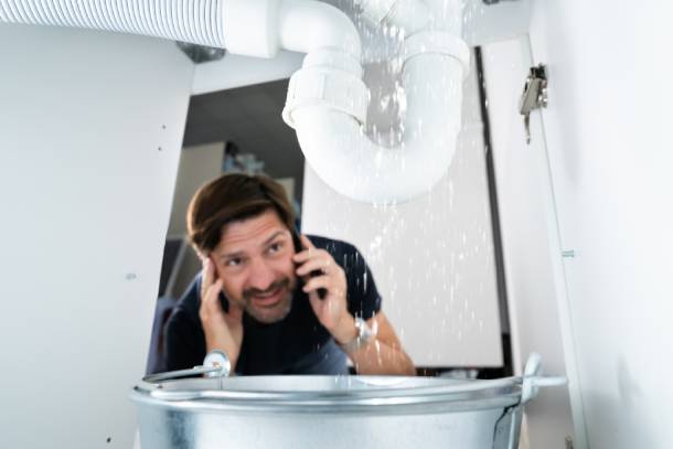 Plumber fixing sink